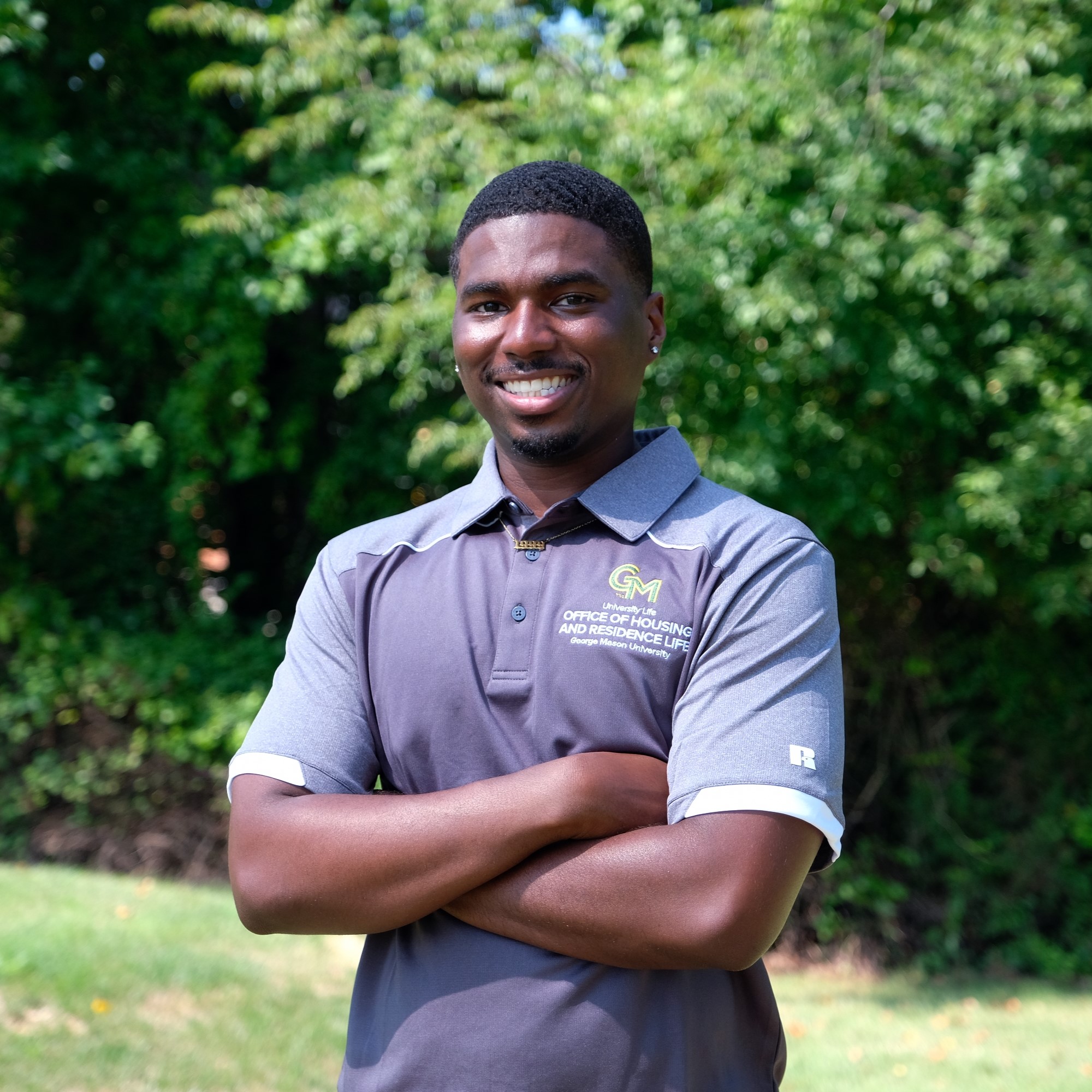 Sheaffeel Gedeon in Gray Mason Polo, Arms crossed Smiling