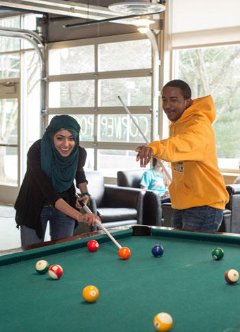 Mason students play pool in the Hub